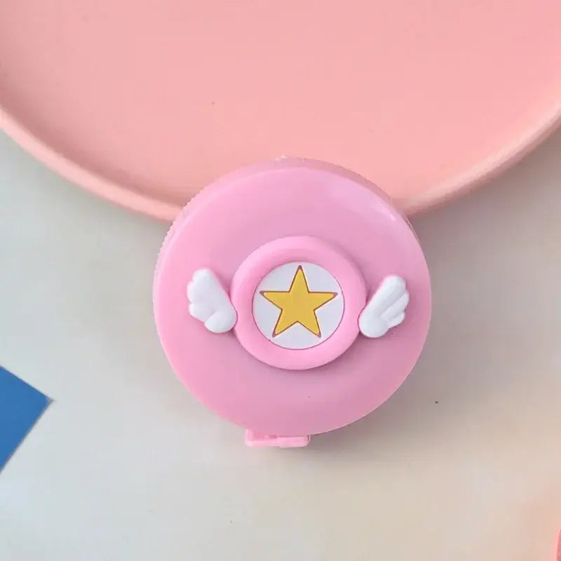 Cute pink tape measure with star and wings design, perfect for craft projects and playful decorations.