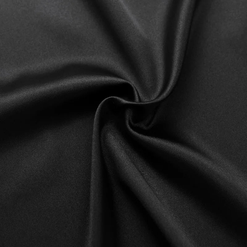 Close-up of luxurious black satin fabric, showcasing its smooth texture and sheen, perfect for elegant garments.