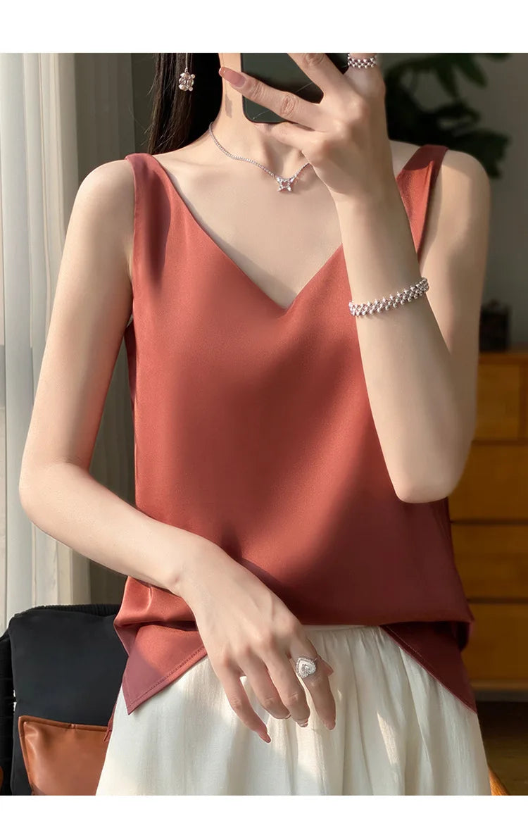 Model wearing a v-neck tank top in a warm hue, perfect for summer, showcasing elegant style and comfort.
