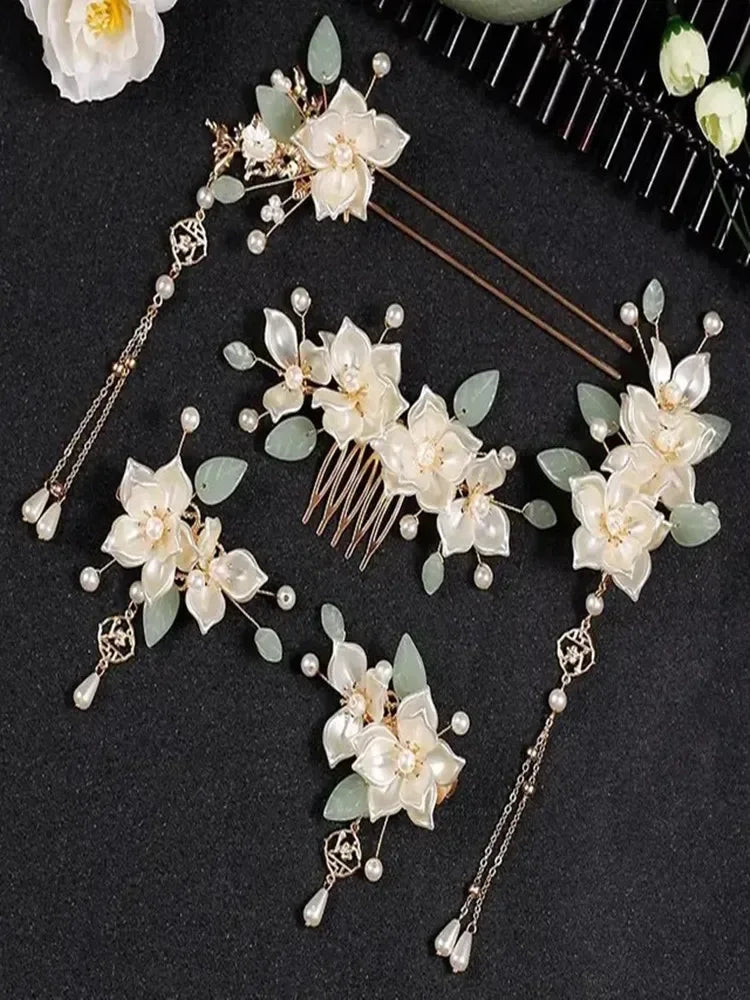 Elegant floral hair accessories set featuring cream flowers and green leaves, perfect for special occasions or bridal looks.