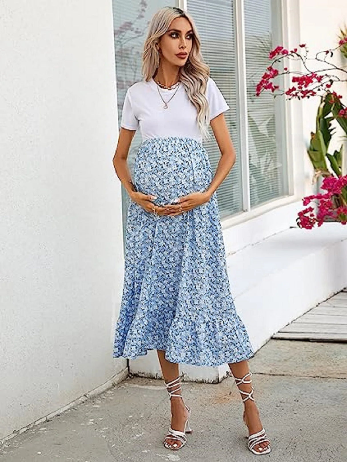 Model wearing a comfortable floral mid-calf maternity dress, perfect for spring and summer, showcasing casual style for expectant mothers.