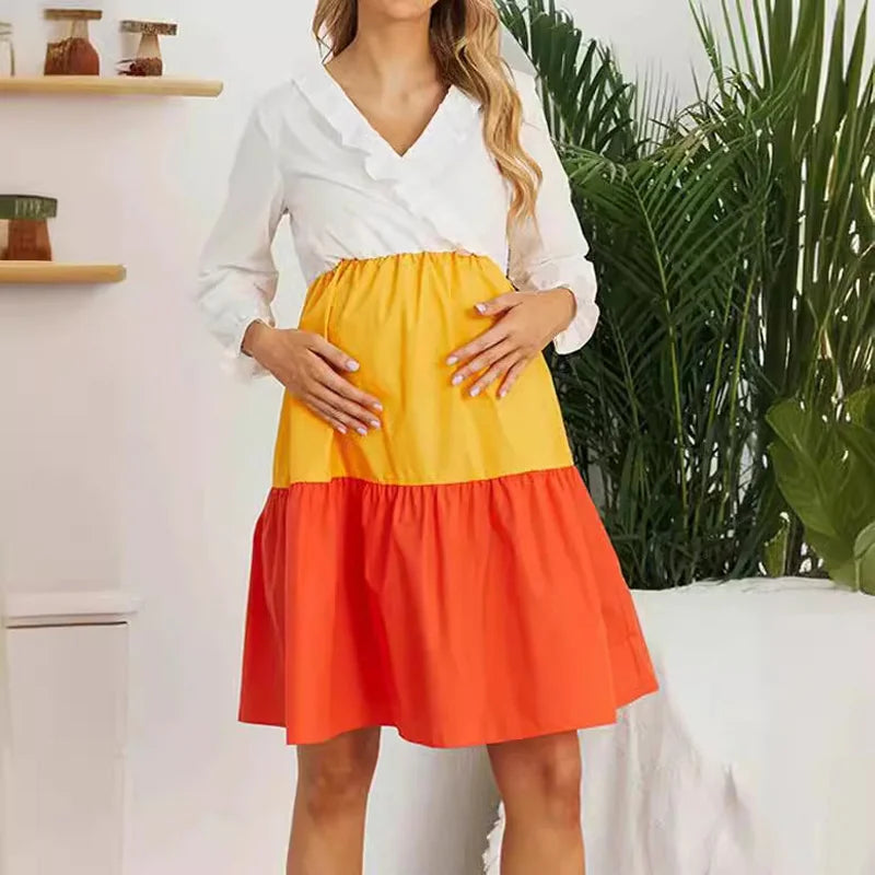 V-Neck color contrast maternity dress with long sleeves in yellow and orange, ideal for summer.