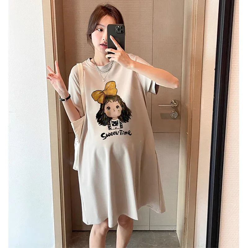 Maternity T-shirt dress with cartoon design, boat neck, and knee-length, perfect for casual summer wear.
