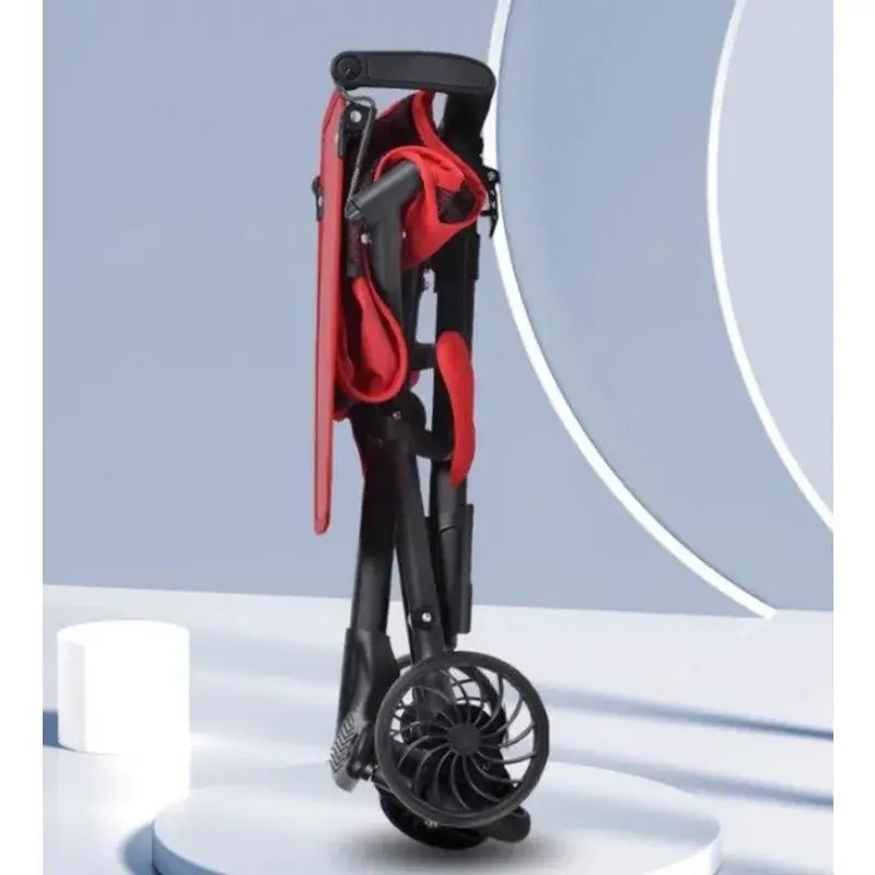 Lightweight baby stroller in foldable design, featuring a black and red color scheme, showcased on a minimalist backdrop.