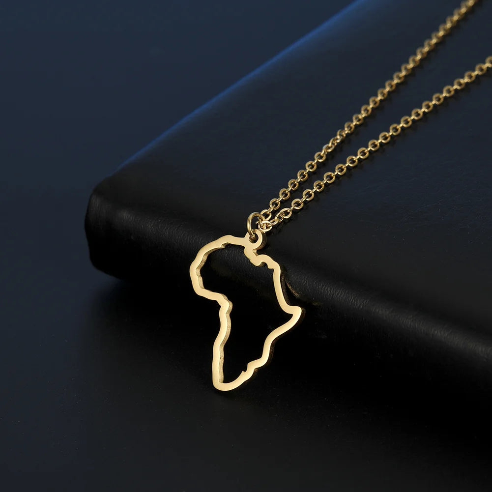 African map gold pendant necklace resting on a black surface, showcasing its unique design and elegance.