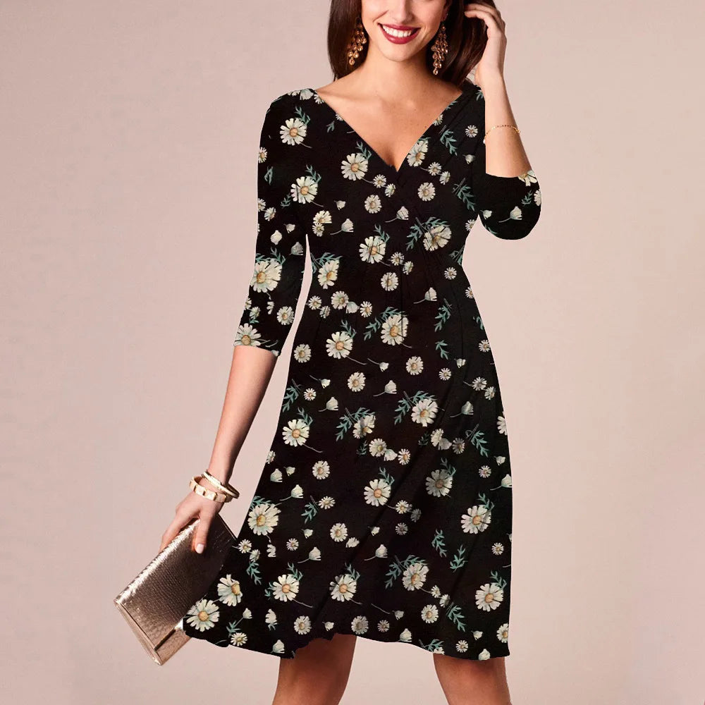 Woman wearing a floral V-neck knee-length maternity dress, summer nursing dress in black with daisies.