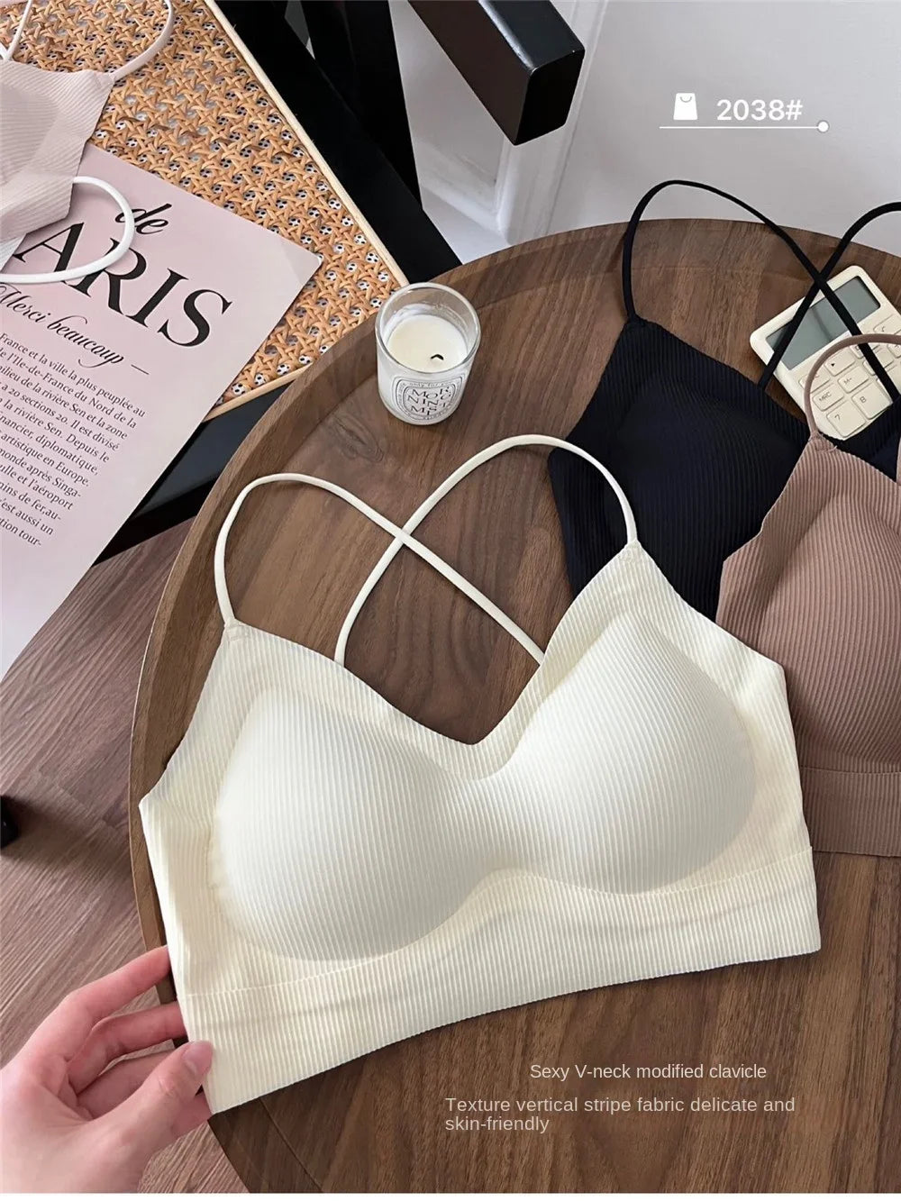 CrossForm™ padded backless tank top in soft, stretchy nylon on wooden table, showcasing v-neck and versatile colors.