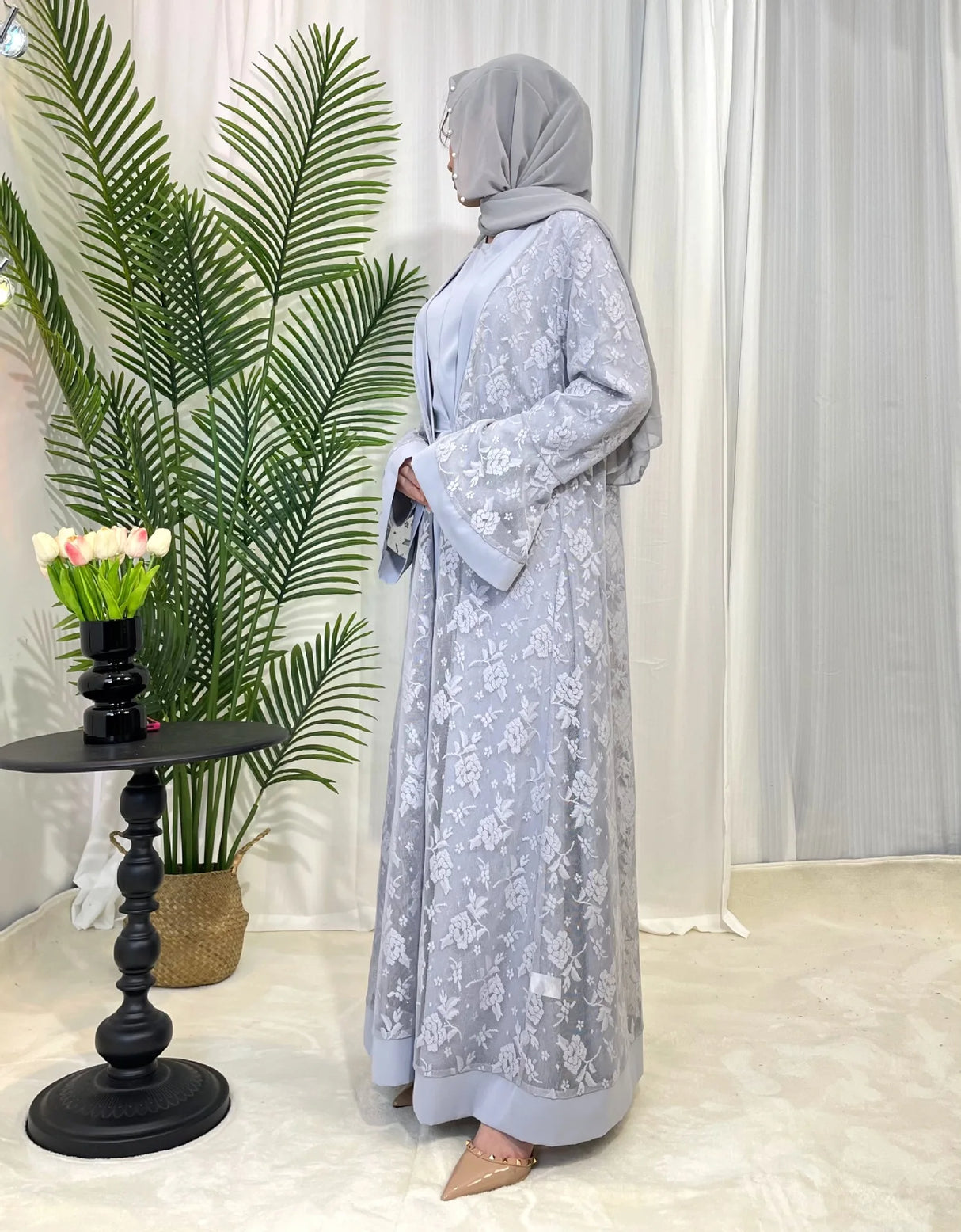 Elegant Dubai Moroccan Kaftan in light gray, showcasing Islamic dress style with floral patterns and open stitch design.