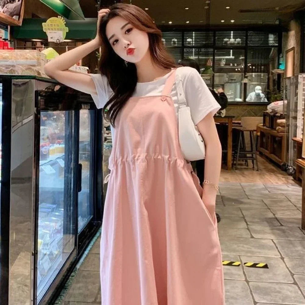 Korean loose fit maternity dress in pink, perfect for holiday photography and casual outings, worn by a young woman.