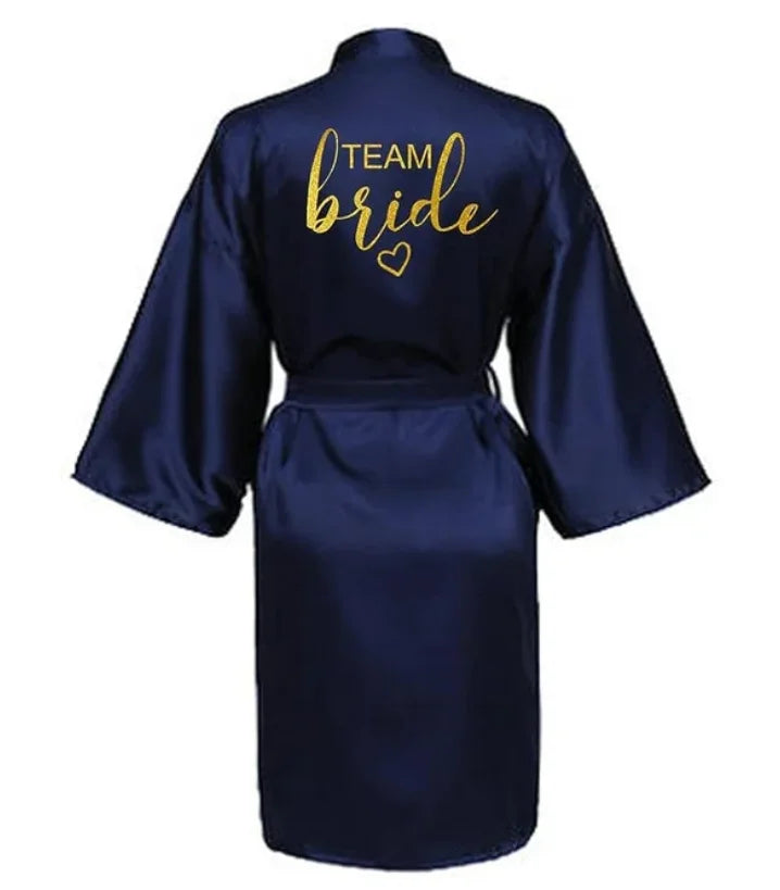 Navy satin kimono robe with 'TEAM bride' in gold lettering, perfect for bridal party wear.