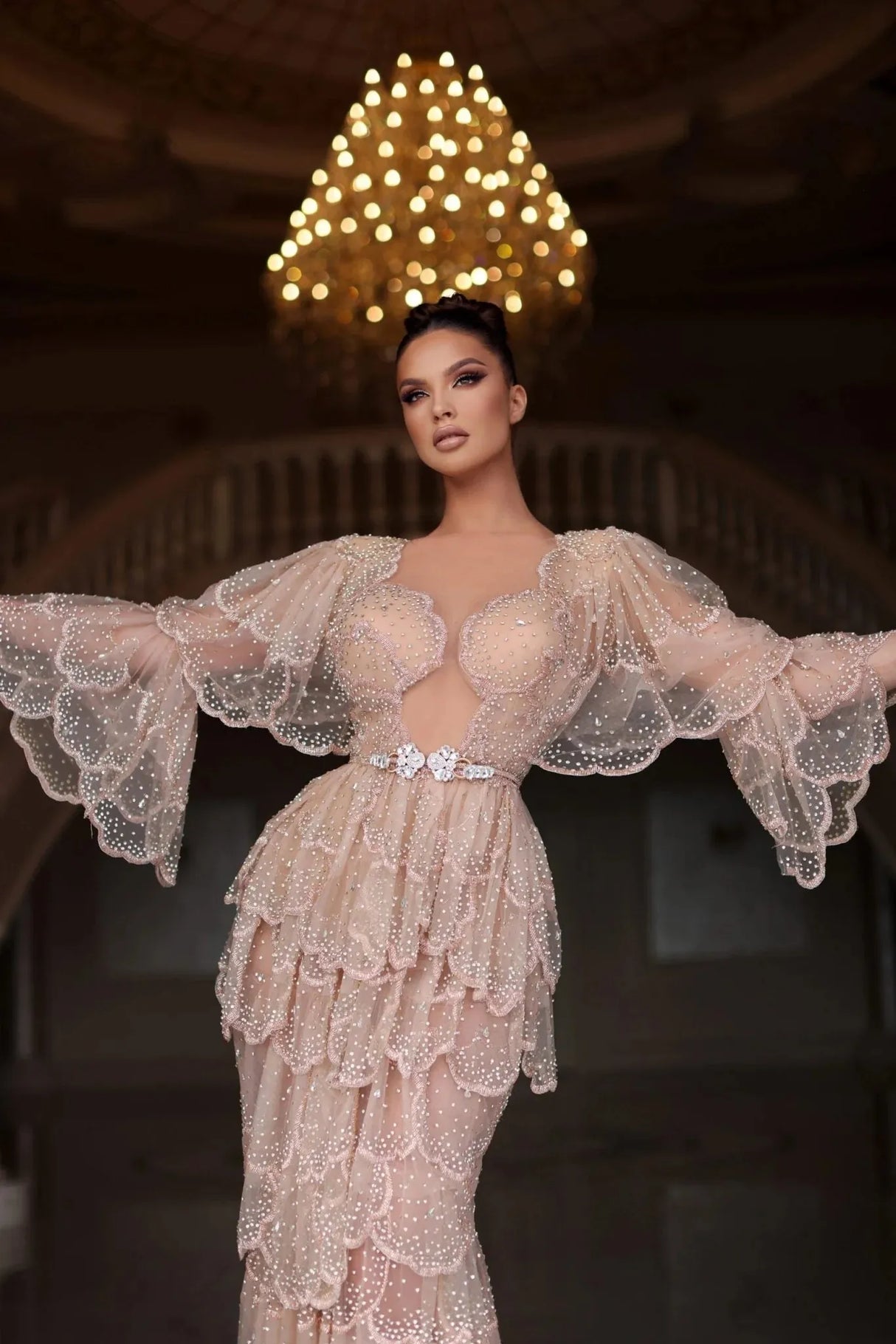 Elegant Arabic nude stone wedding gown with tiered sleeves and sweetheart neckline, featuring beaded details.