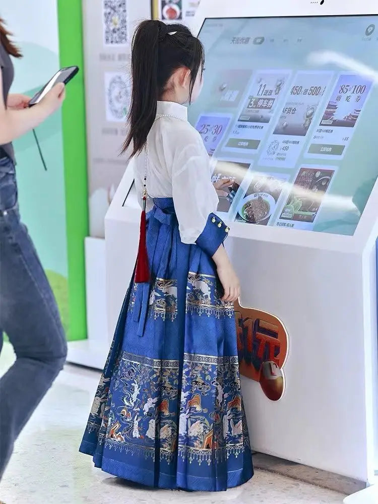 Girl wearing an embroidered blue Summer Hanfu dress, interacting with a digital kiosk in a modern setting.