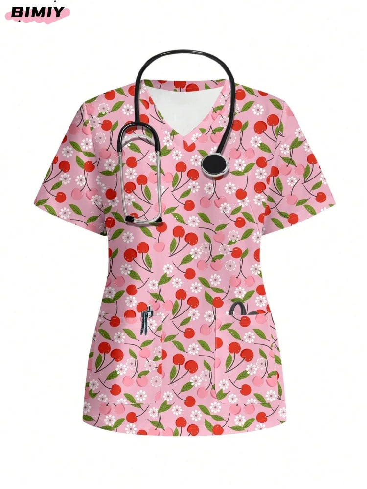 Colorful pink nurse scrub top with cherry floral pattern, featuring a V-neck and stethoscope, perfect for medical professionals.