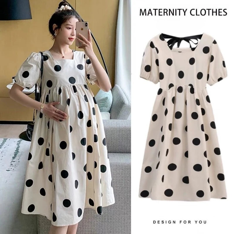 Polka dot loose maternity dress in cream with black dots, perfect for summer, featuring a short sleeve and ball gown silhouette.