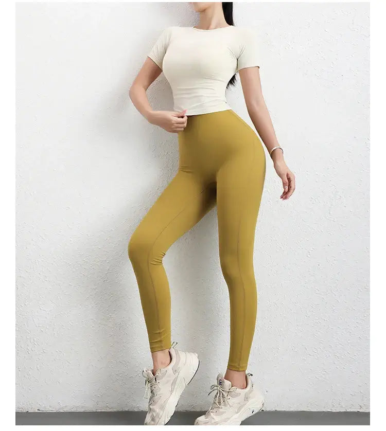 قميص رياضي نسائي ضاغط بأكمام قصيرة بدون درزات