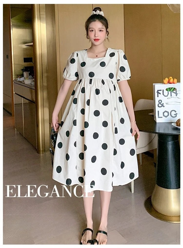 Polka dot loose maternity dress by YIGUDAR, white with black dots, mid-calf length, featuring short sleeves, perfect for summer.