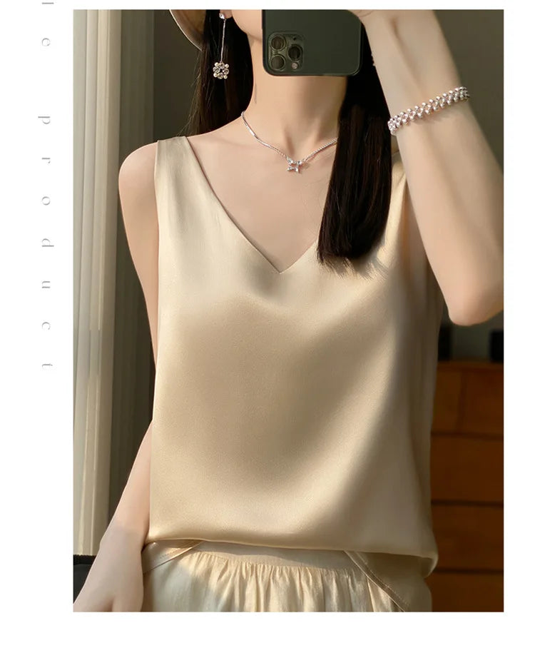 Woman wearing a satin V-neck camisole in beige, showcasing summer elegance and comfort.