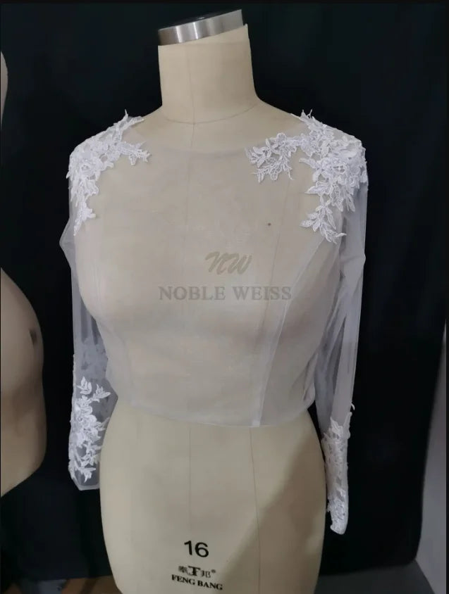 Lace Bridal Bolero with long sleeves and floral appliques for wedding outfits by Noble Weiss.