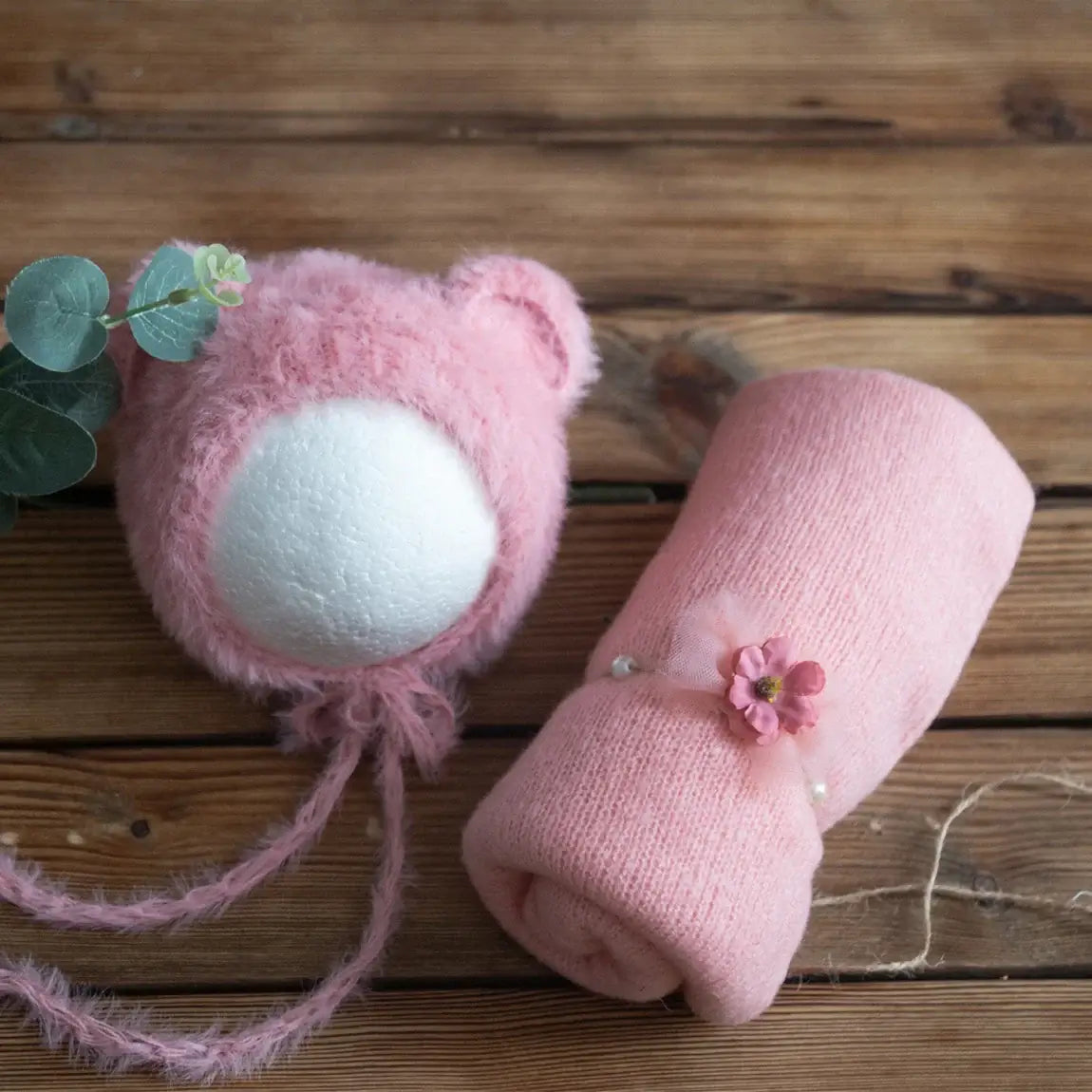 Newborn pink stretch knit mohair bear hat and matching swaddle wrap on wooden background, perfect for 0-1Y unisex baby photography.