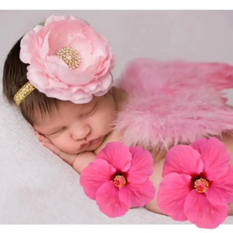 Newborn baby girl with pink angel wings and floral headband, perfect for photography props and costumes.