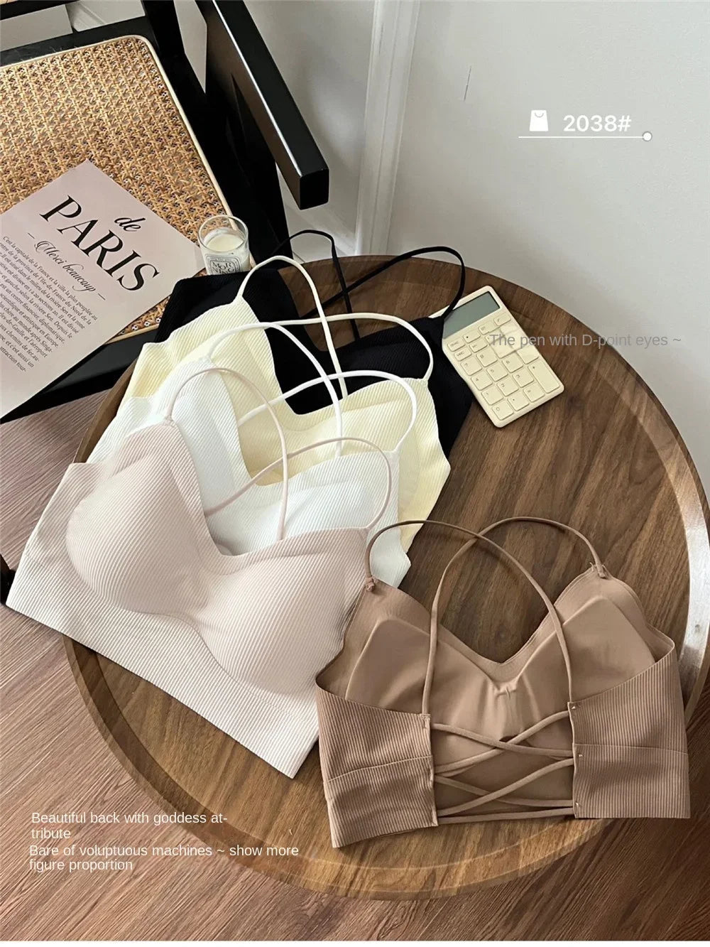 CrossForm™ padded backless tank tops in various colors on a wooden table, perfect for summer wear.