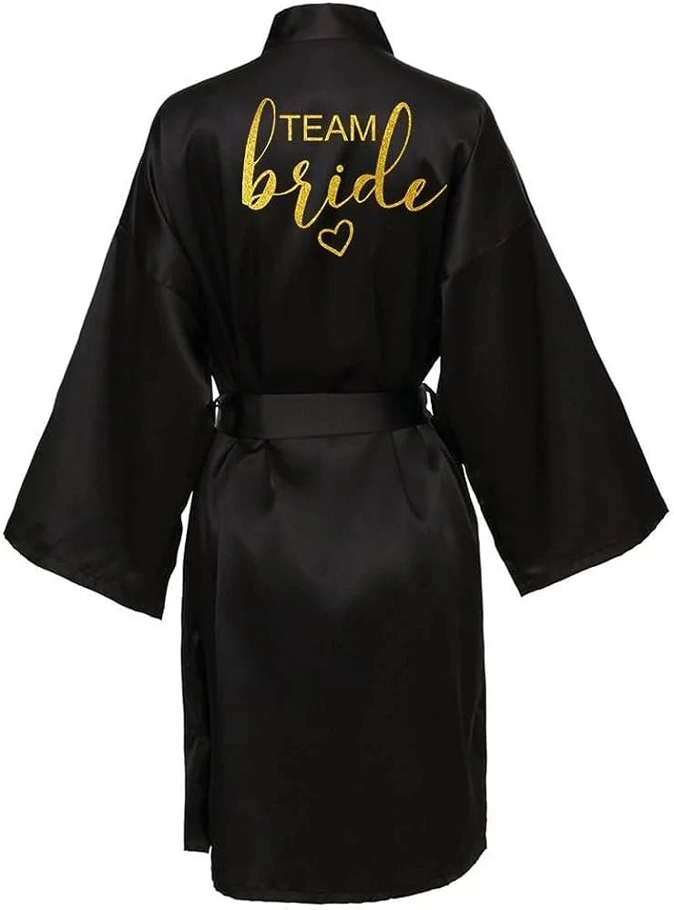 Black satin kimono robe with gold 'TEAM Bride' lettering, perfect for bridal parties and celebrations.