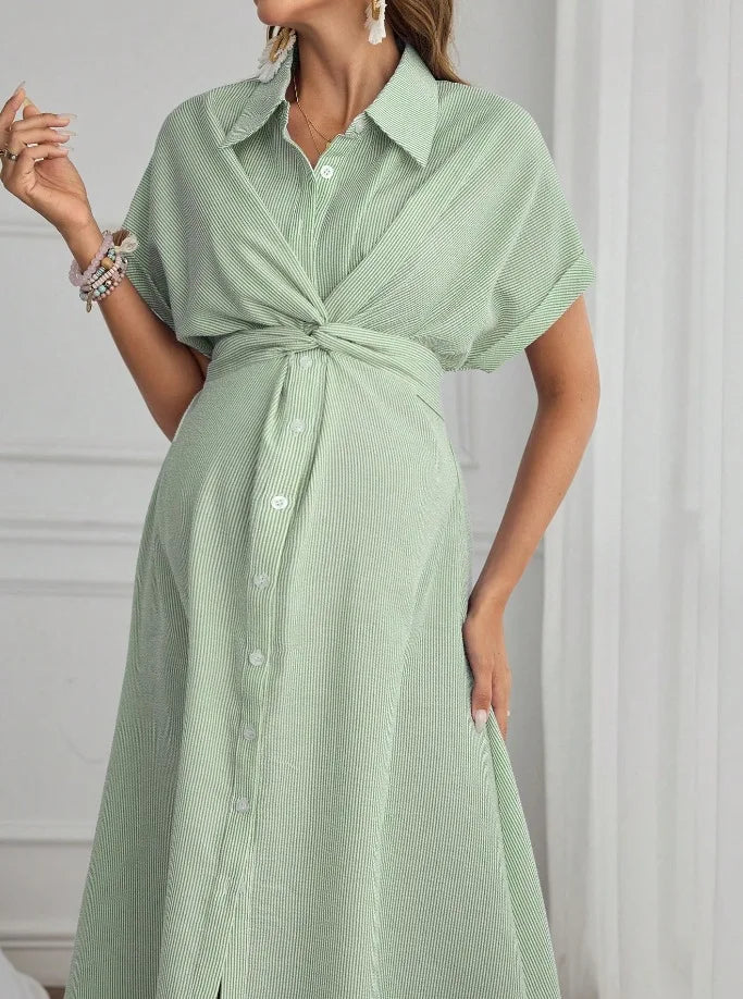 Women’s striped short sleeve maternity shirt dress in green, featuring a knotted front and soft fabric for comfort.