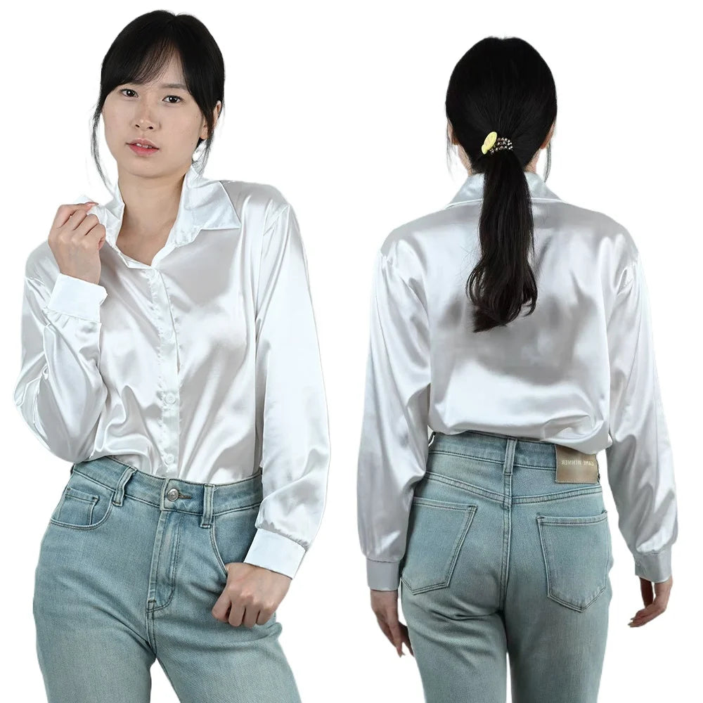 SilkAura™ imitation silk blouse in white, featuring a loose fit and button closure, paired with high-waisted jeans.