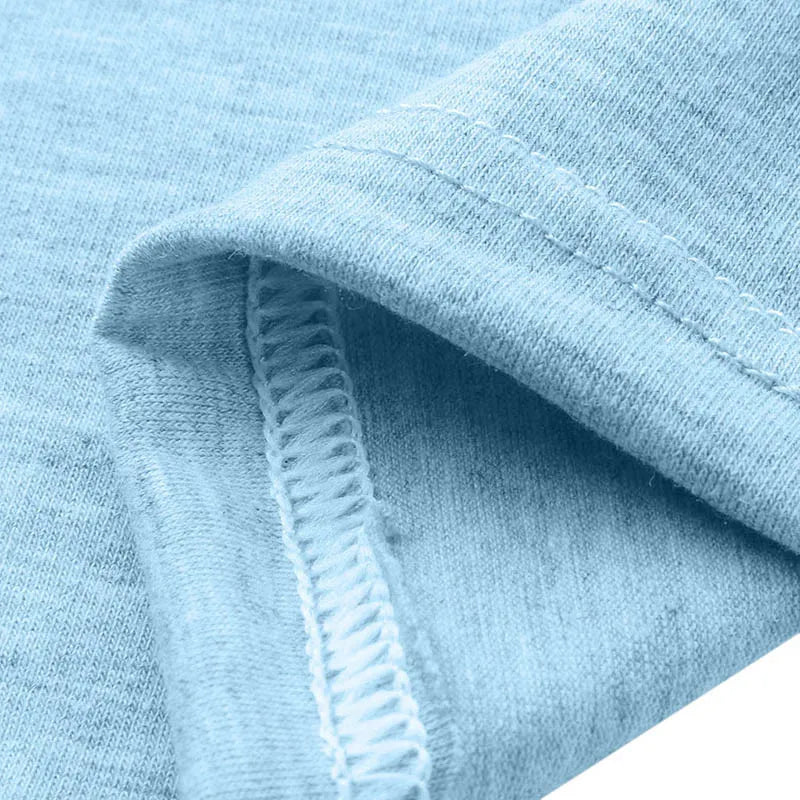 Close-up of a light blue cotton fabric emphasizing the stitch quality and softness suitable for casual wear.
