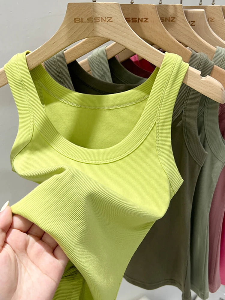 RibFlex™ Basic O-Neck Tank in bright green, showcasing ribbed texture and summer style, hanging with other colorful vests.