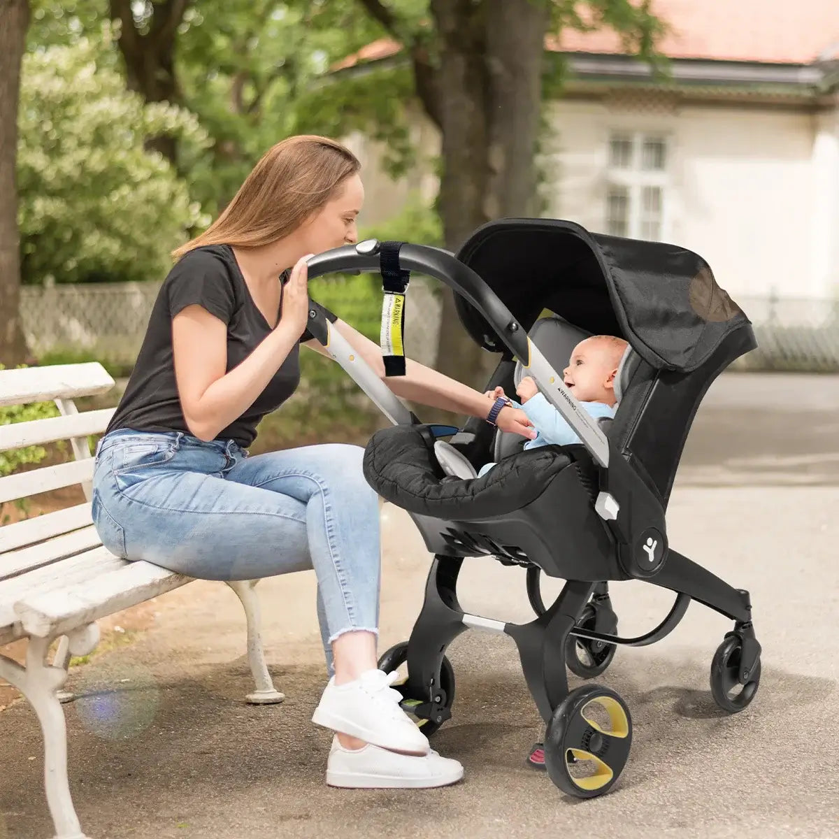Mom interacting with baby in a foldable baby stroller with a metal frame, ideal for infants up to 2 years.