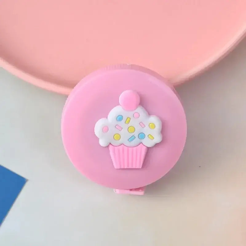 Cute pink cupcake tape measure with colorful sprinkles, perfect for fun and whimsical home decor.