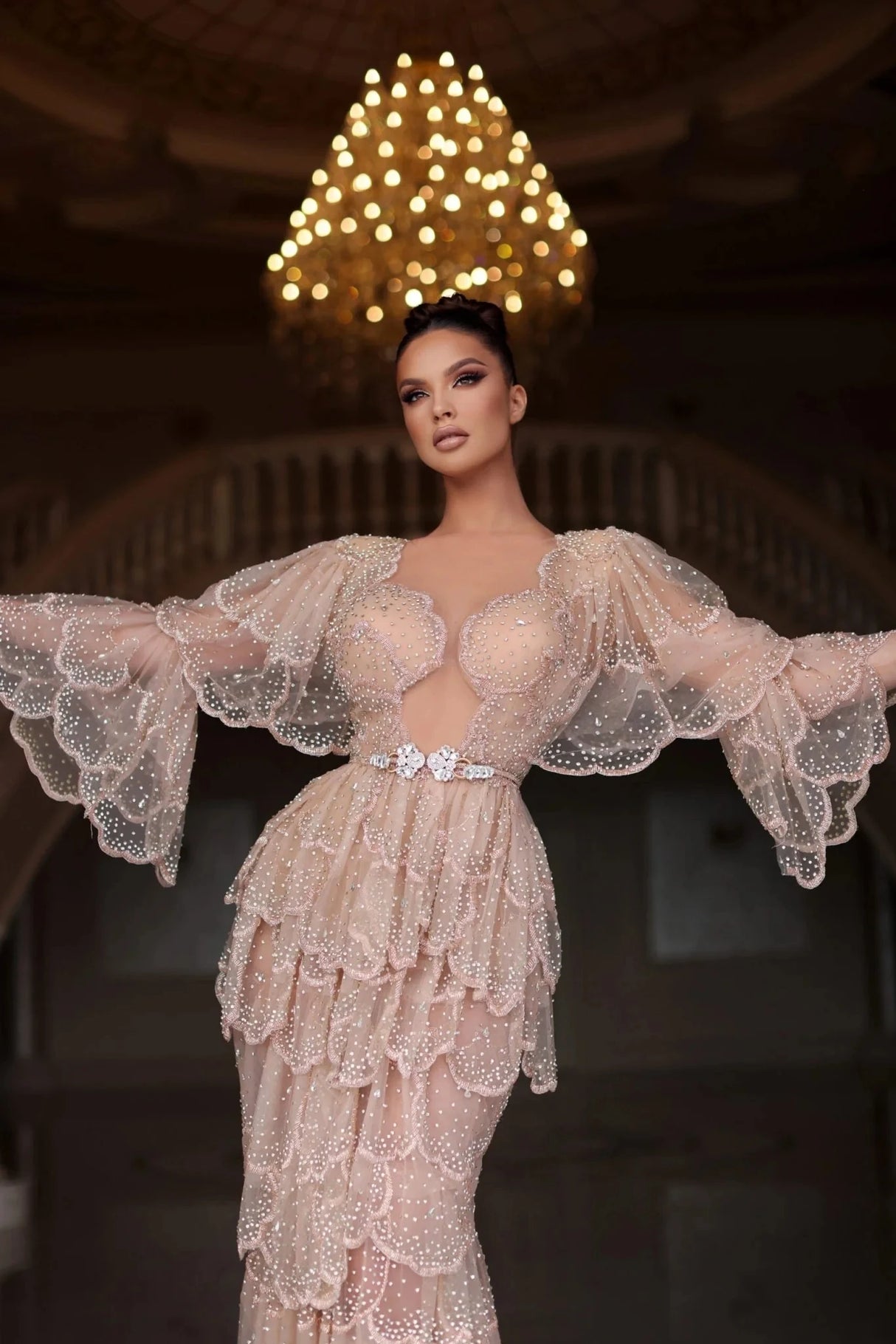 Elegant Arabic nude stone wedding gown with tiered sleeves and beaded embellishments, perfect for special occasions.