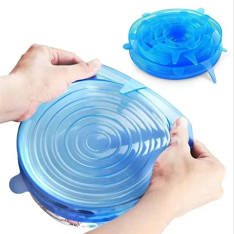 Hands using adjustable blue silicone food cover for airtight sealing of bowls.
