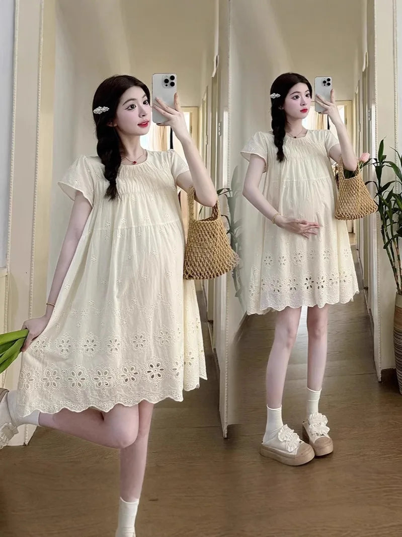 A-Line cotton maternity dress in hollowed out style, knee-length, featuring a boat neck and floral embroidery.