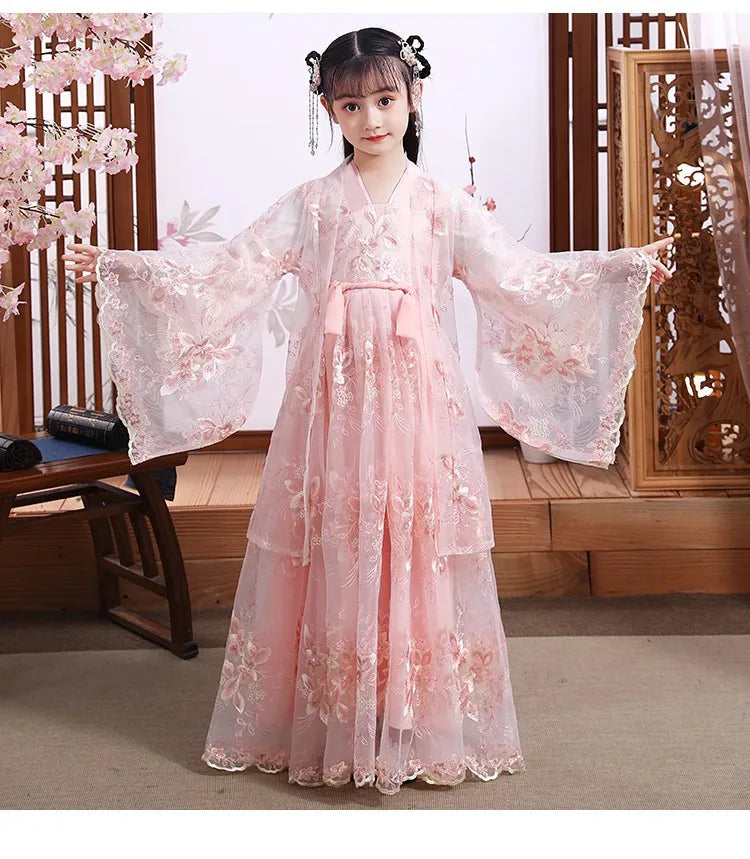A girl wearing a pink Modern Fairy Hanfu dress with floral embroidery, designed for cosplay and themed events.