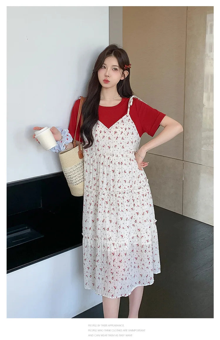 Model wearing a floral two-piece maternity skirt with a red top, showcasing summer style and comfort.