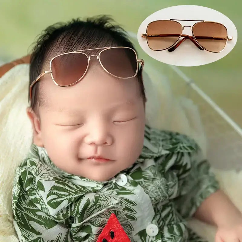 Newborn baby wearing colorful sunglasses, featuring round and heart shapes, perfect for photography accessories.