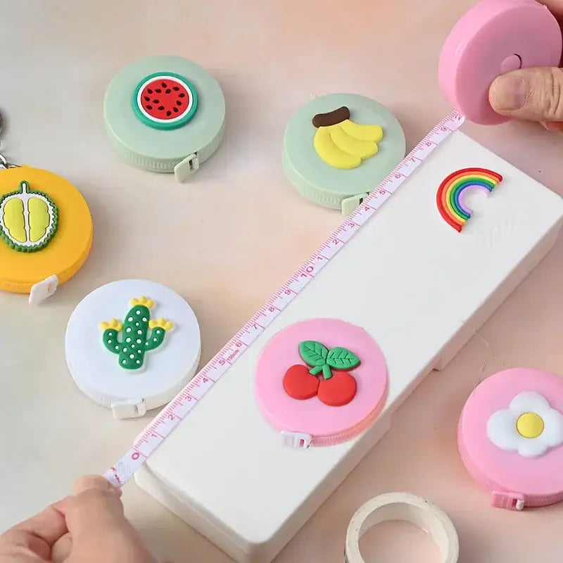 Colorful mini tape measure with fruit and design features, perfect for measuring small items or kids' heights.