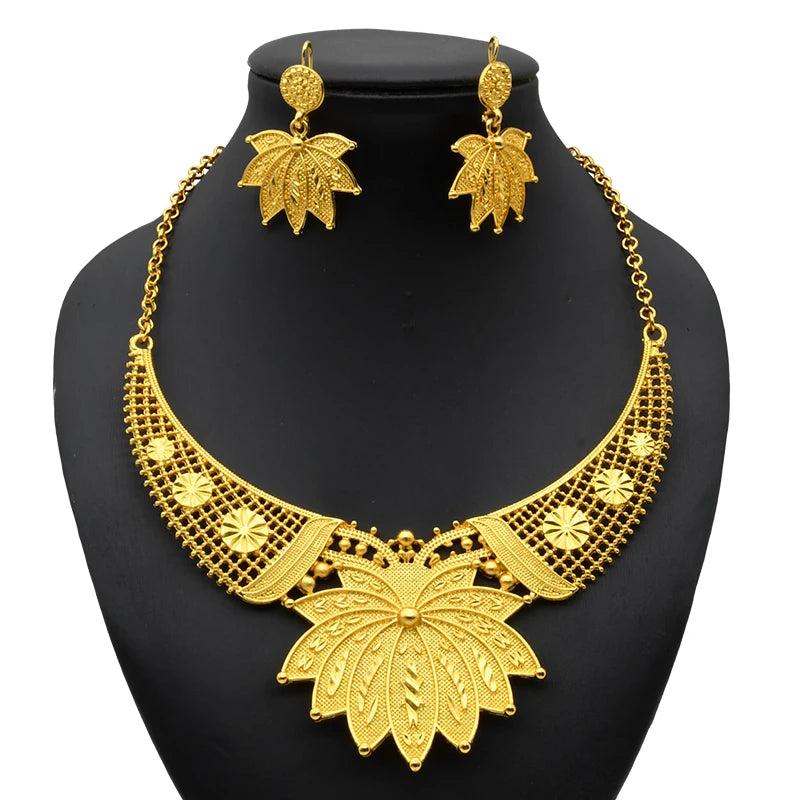 Luxury Indian bridal jewelry necklace set with elegant leaf design in gold, featuring matching earrings for weddings.