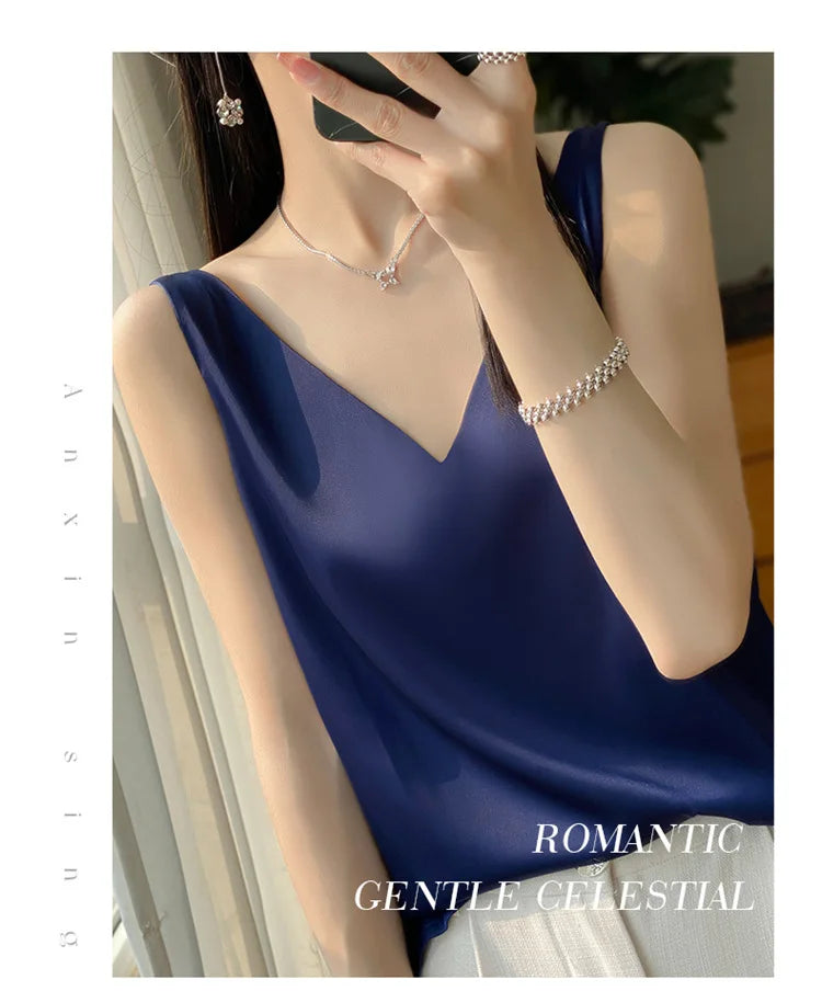 Model wearing a navy blue satin v-neck camisole, showcasing a chic summer outfit for casual and elegant settings.