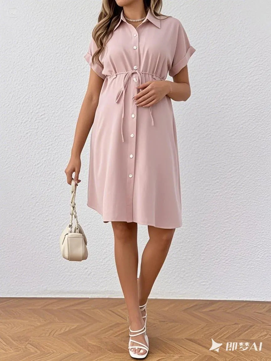 Maternity casual summer dress in light pink with button closure and tie waist detail, perfect for expecting mothers.