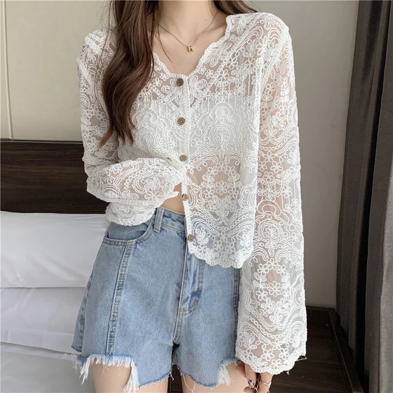 SheerCharm lace long sleeve sun shirt for women, featuring a V-neck and button closure, paired with casual denim shorts.