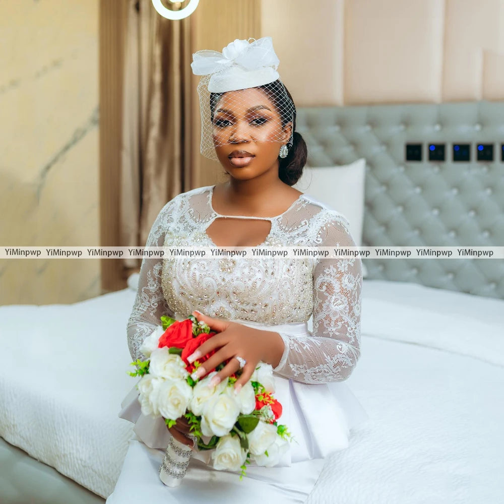 Elegant bride in African lace mermaid wedding dress with crystal details, holding bouquet in a luxurious setting.