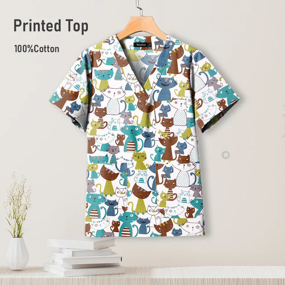 Pediatric hospital surgical scrub top featuring colorful cat print, made from breathable 100% cotton.