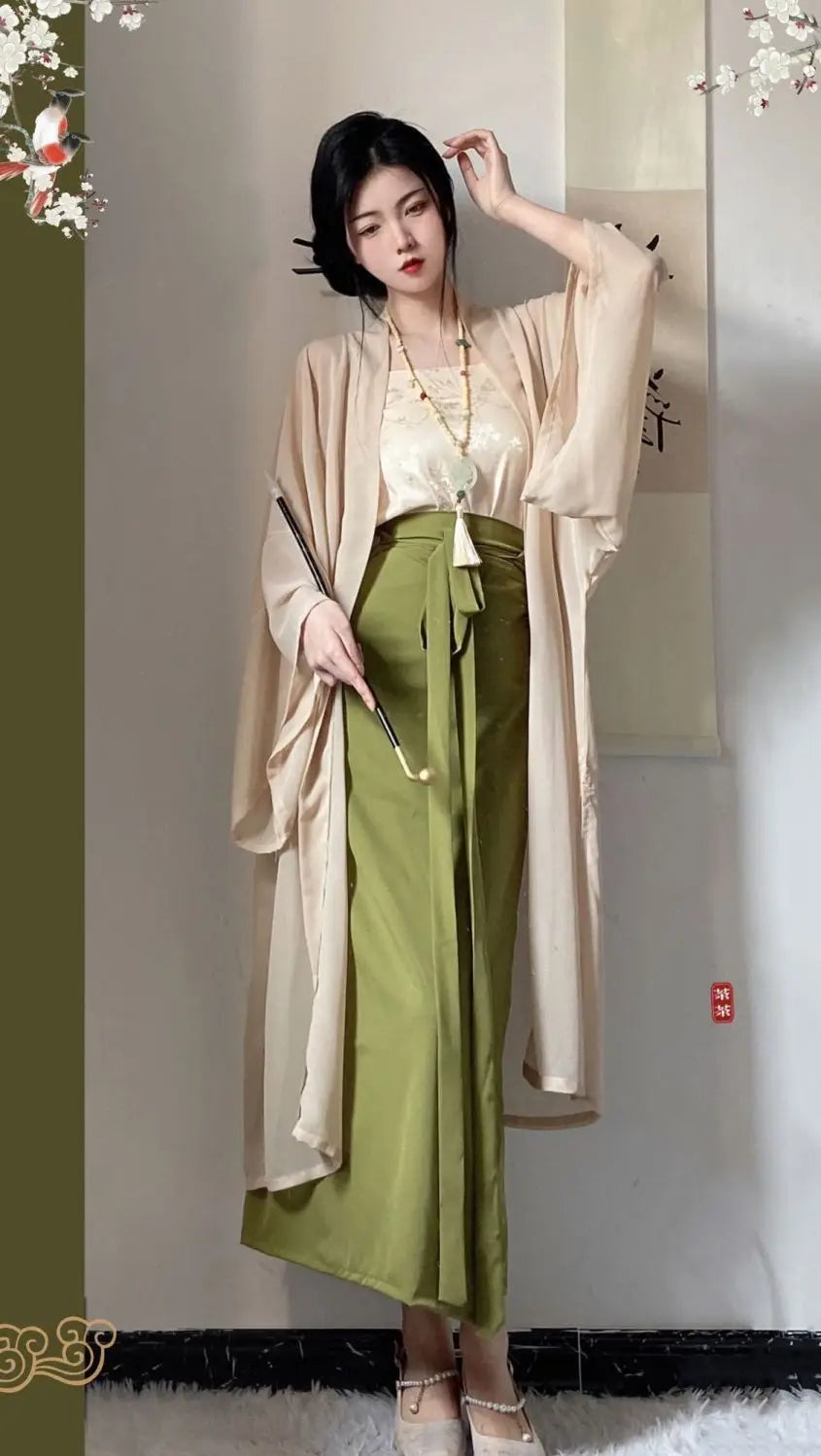 Elegant woman wearing a Princess Song Dynasty Hanfu 3-piece robe, featuring a flowing beige outer layer and green trousers.