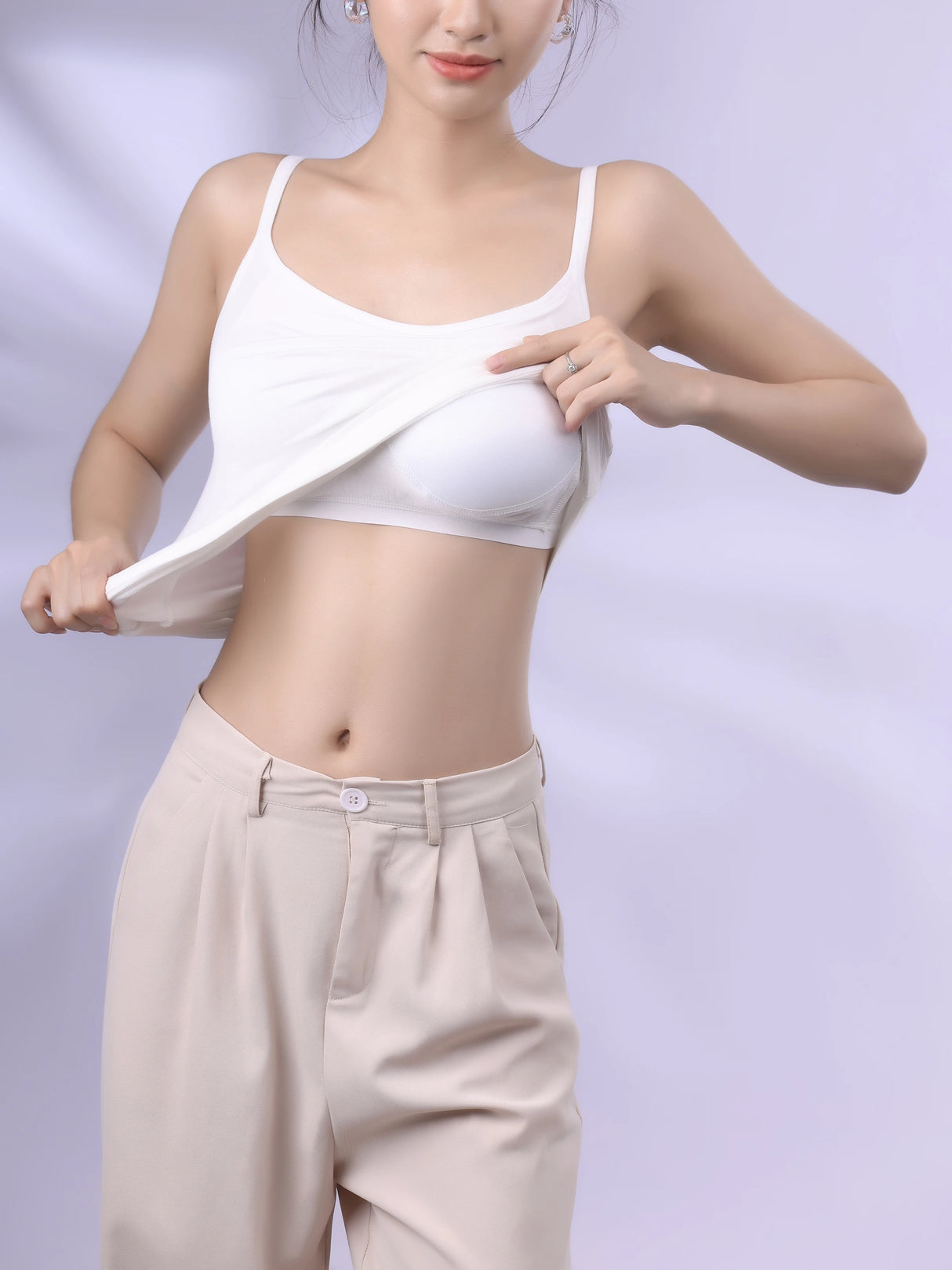 Model demonstrating the Bralux™ built-in bra camisole with adjustable straps and soft inner layer.