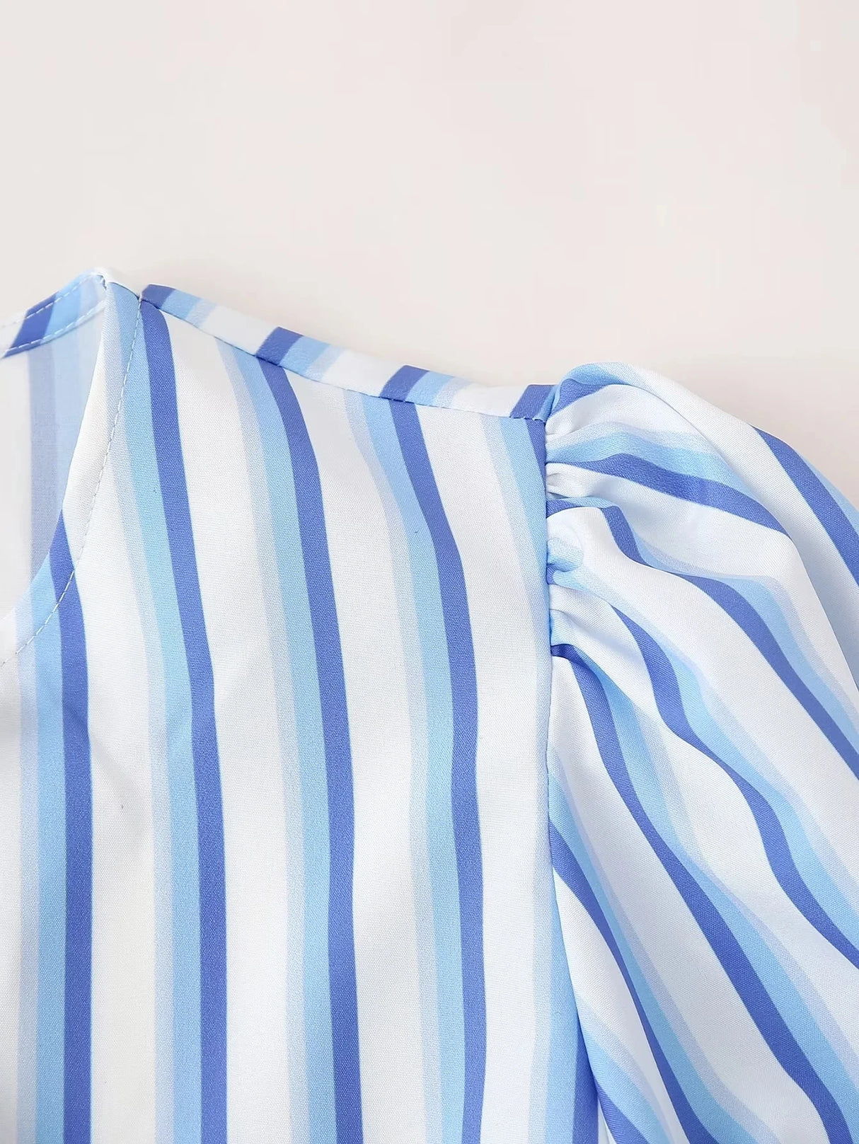 Close-up of BowChic Stripe Lace-Up Blouse showing blue and white striped fabric detail on short sleeves.