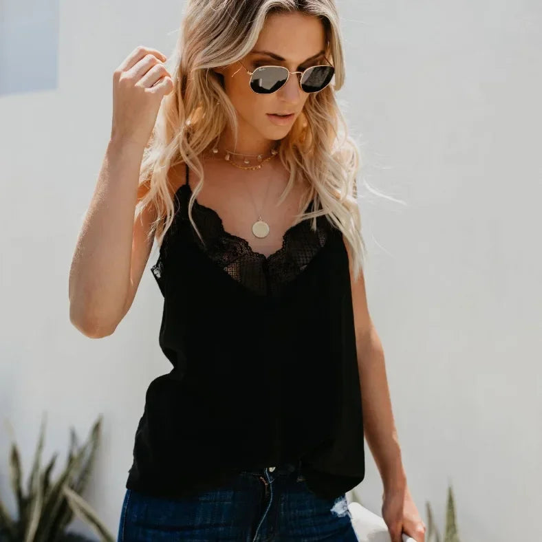 Model wearing SatéBelle™ elegant satin camisole with lace detail and sunglasses in casual setting.