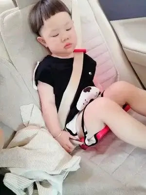 Sleepy child secured in a car seat, showcasing the importance of safety for young passengers.